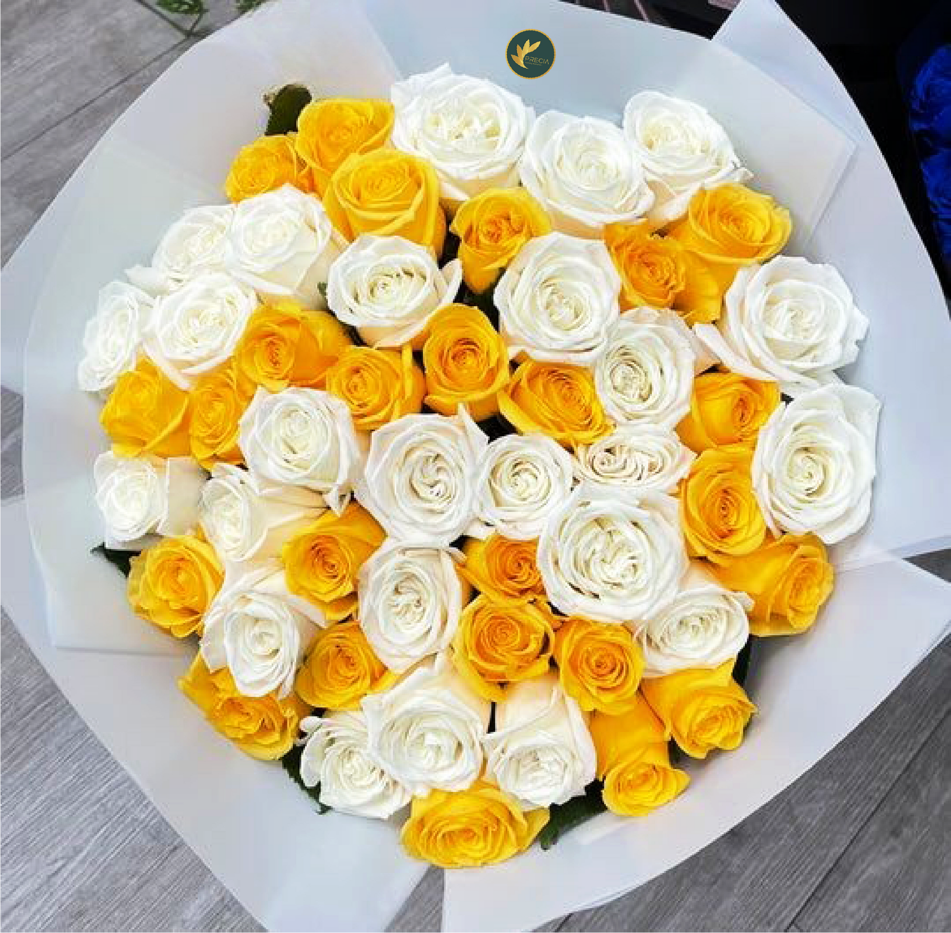 A bouquet of yellow and white roses